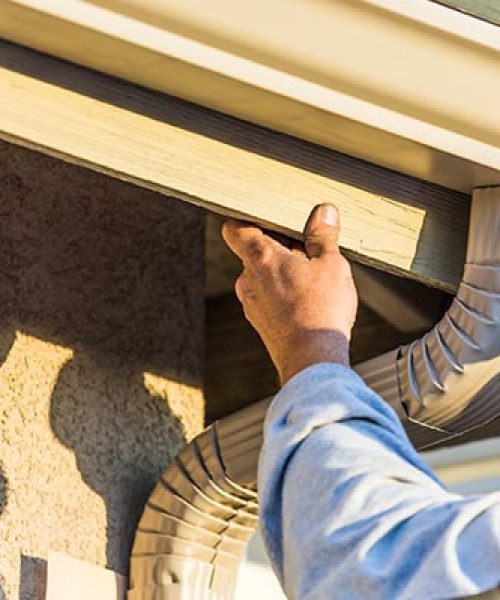 professional worker repairing downspout